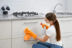 a women cleaning kitchen in Surrey