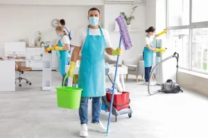Commercial cleaning Surrey team disinfecting and cleaning a modern office space with professional equipment and safety gear.