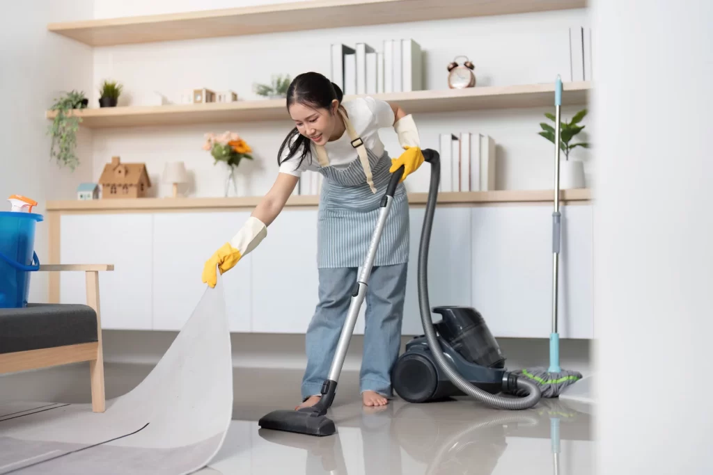 a young woman cleaning the floor of house cleaning Surrey